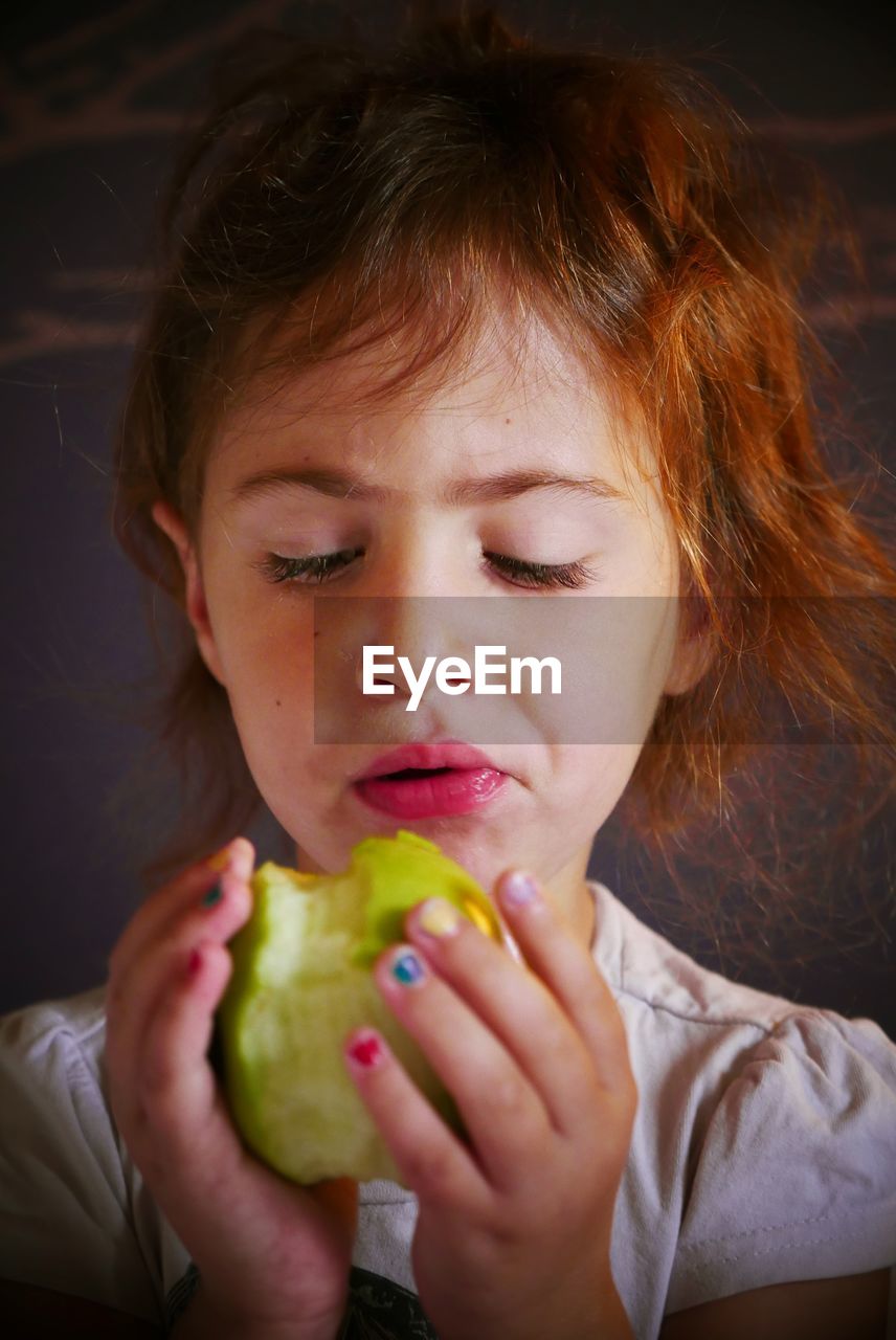 Close-up of girl eating apple
