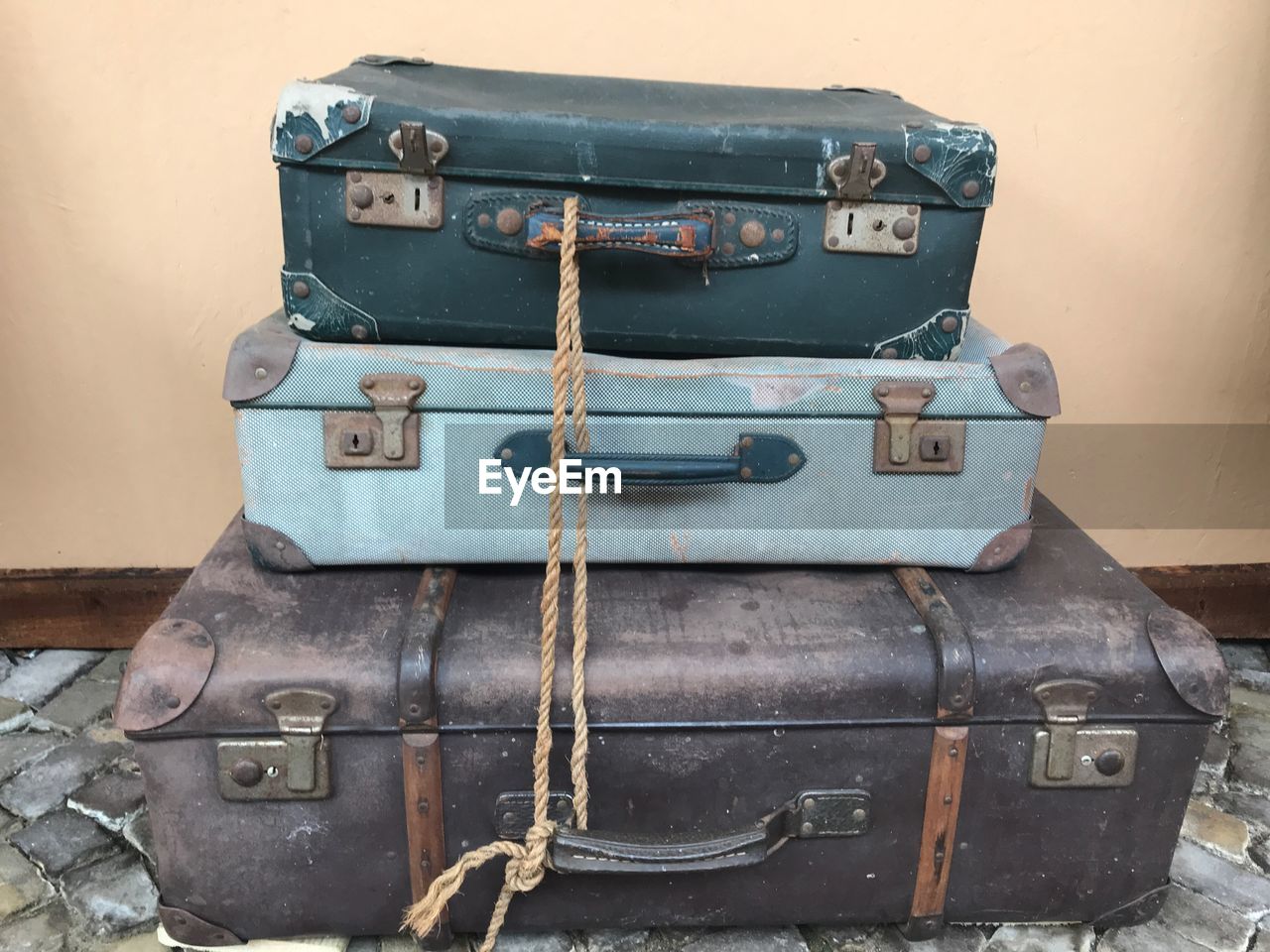 Close-up of old suitcases against wall