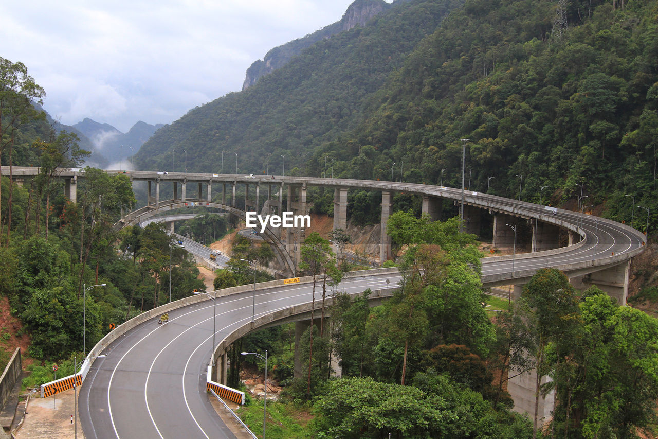 High angle view of road by mountain against sky