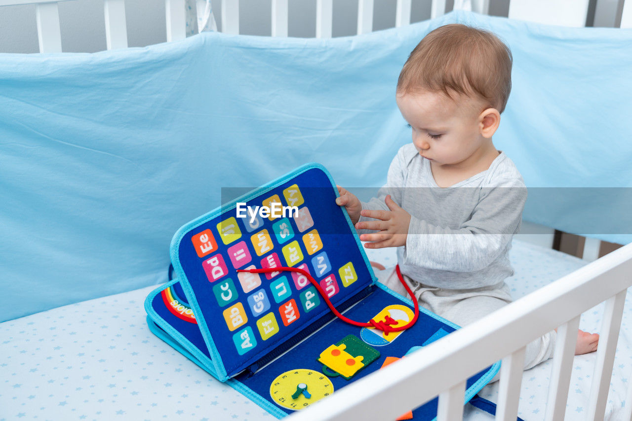 portrait of cute boy playing with toy