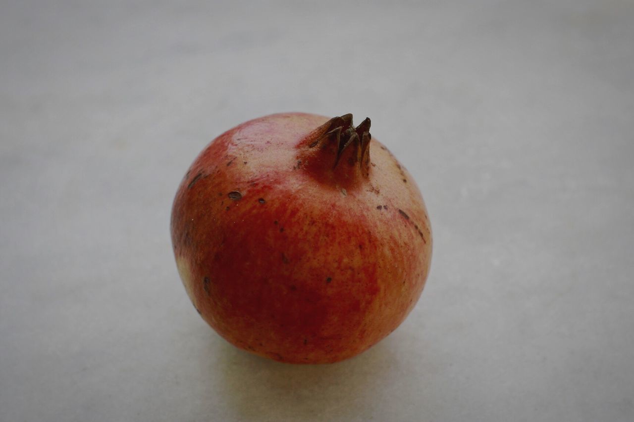 CLOSE-UP OF RED FRUIT ON TABLE