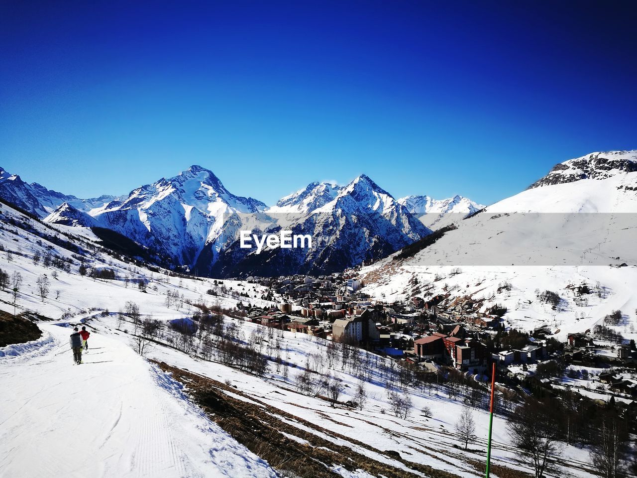 SNOW COVERED MOUNTAINS AGAINST BLUE SKY