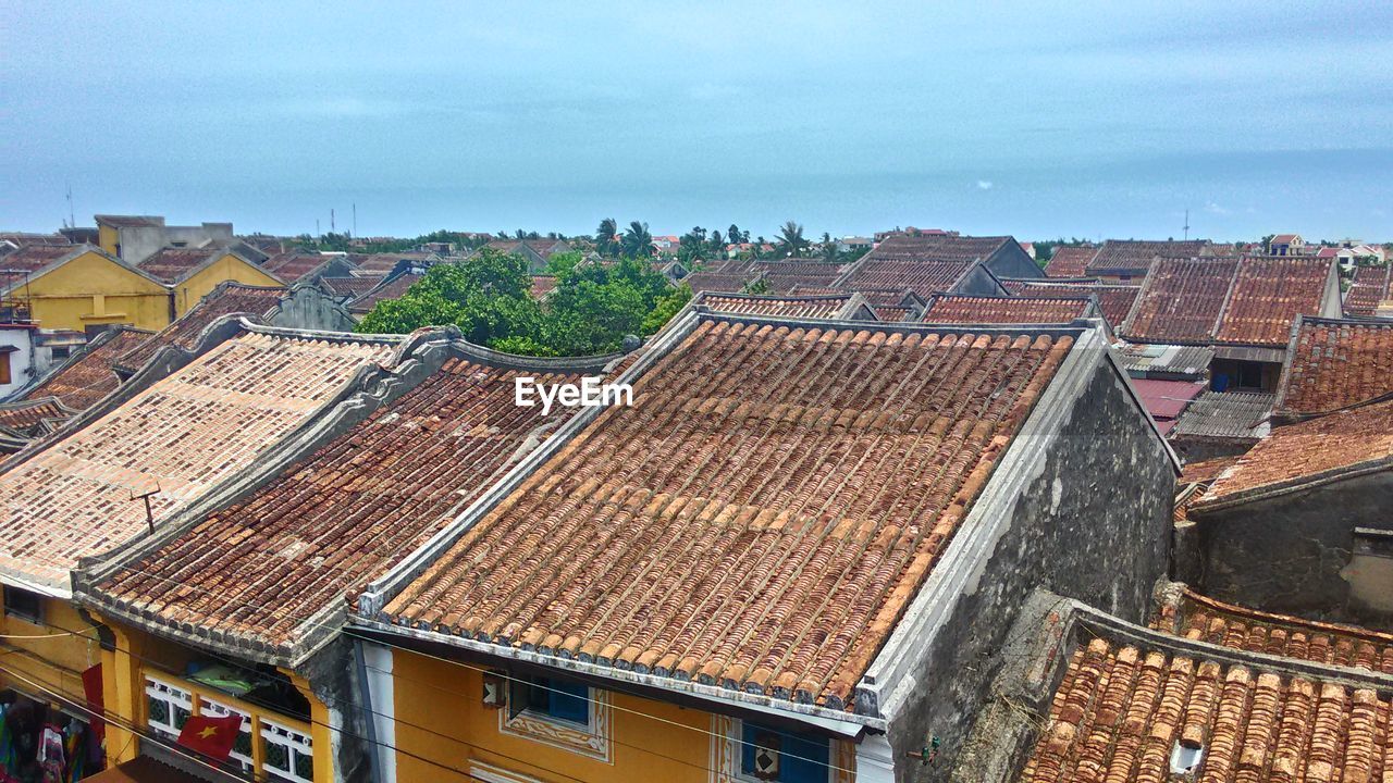 High angle view of cityscape against cloudy sky