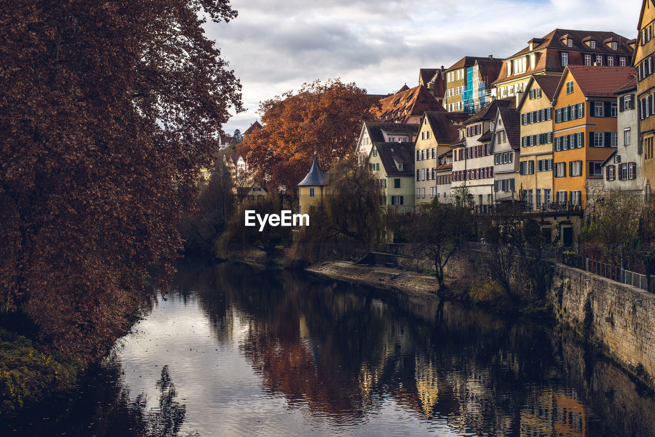 Reflection of trees and buildings in river