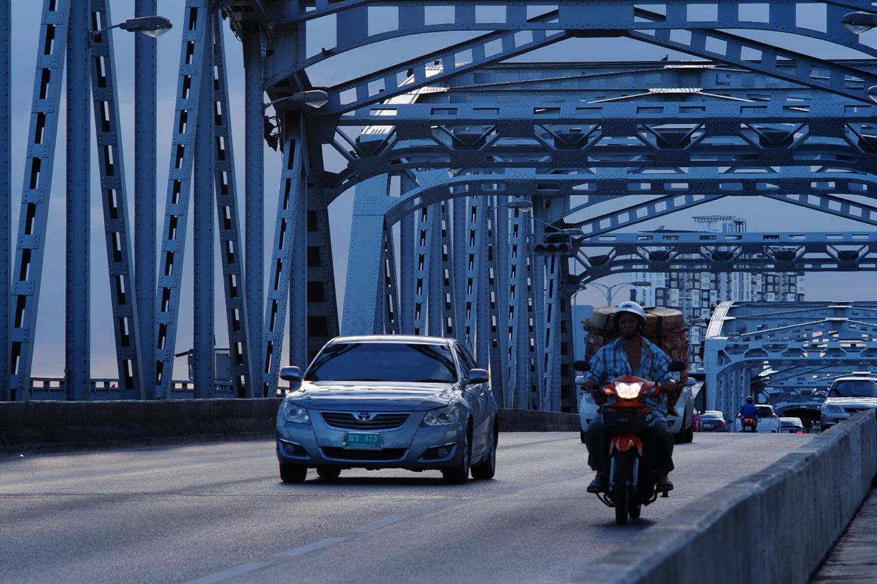 REAR VIEW OF CARS ON BRIDGE