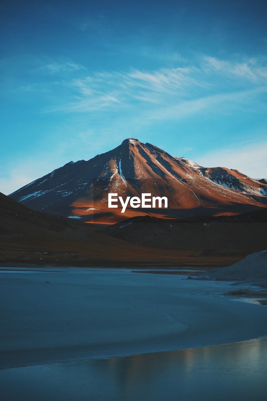 Sea with mountain in background