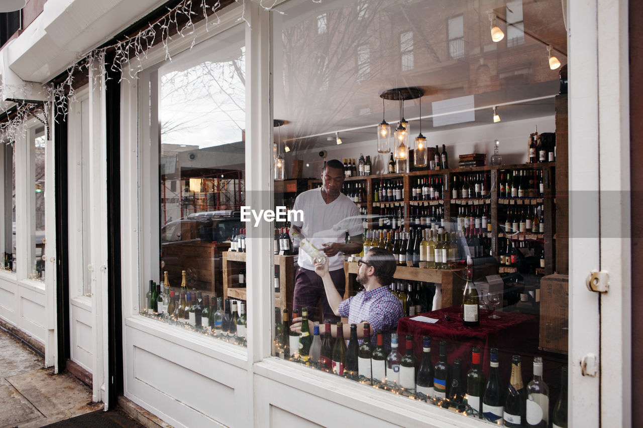 Multi-ethnic colleagues working in wine shop