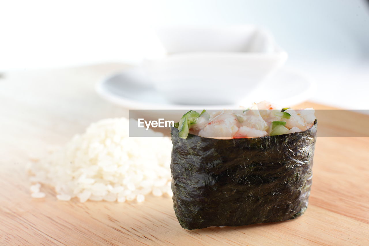 food and drink, food, dish, healthy eating, japanese food, seafood, asian food, wellbeing, cuisine, freshness, rice - food staple, indoors, rice, no people, culture, plate, sushi, meal, table, wood, fish, tableware, vegetable, focus on foreground, crockery, close-up, produce, gourmet