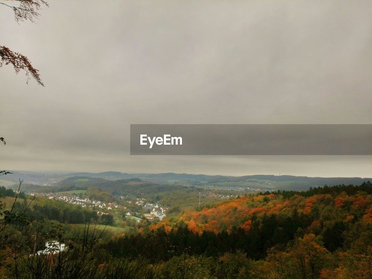 High angle view of city from mountain against cloudy sky