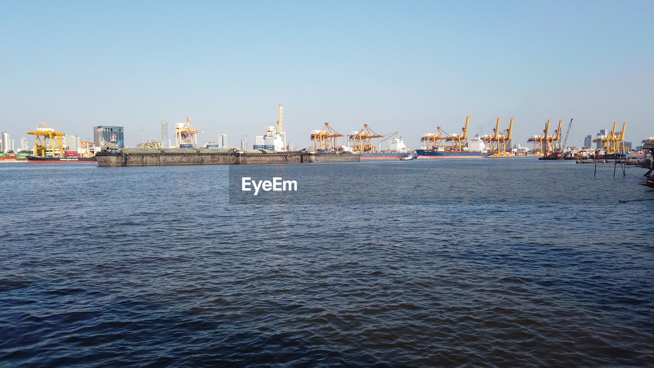 SEA BY PIER AGAINST SKY