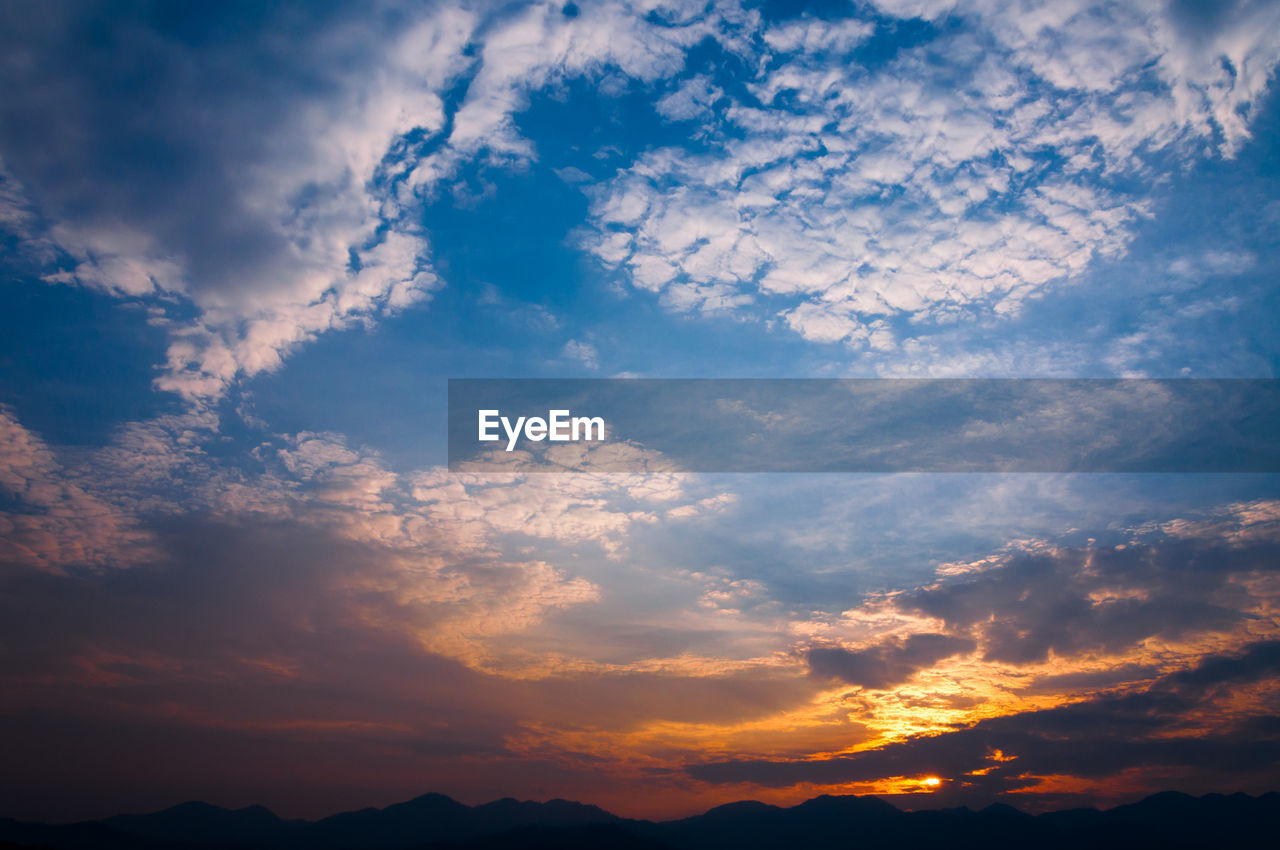 Low angle view of dramatic sky during sunset