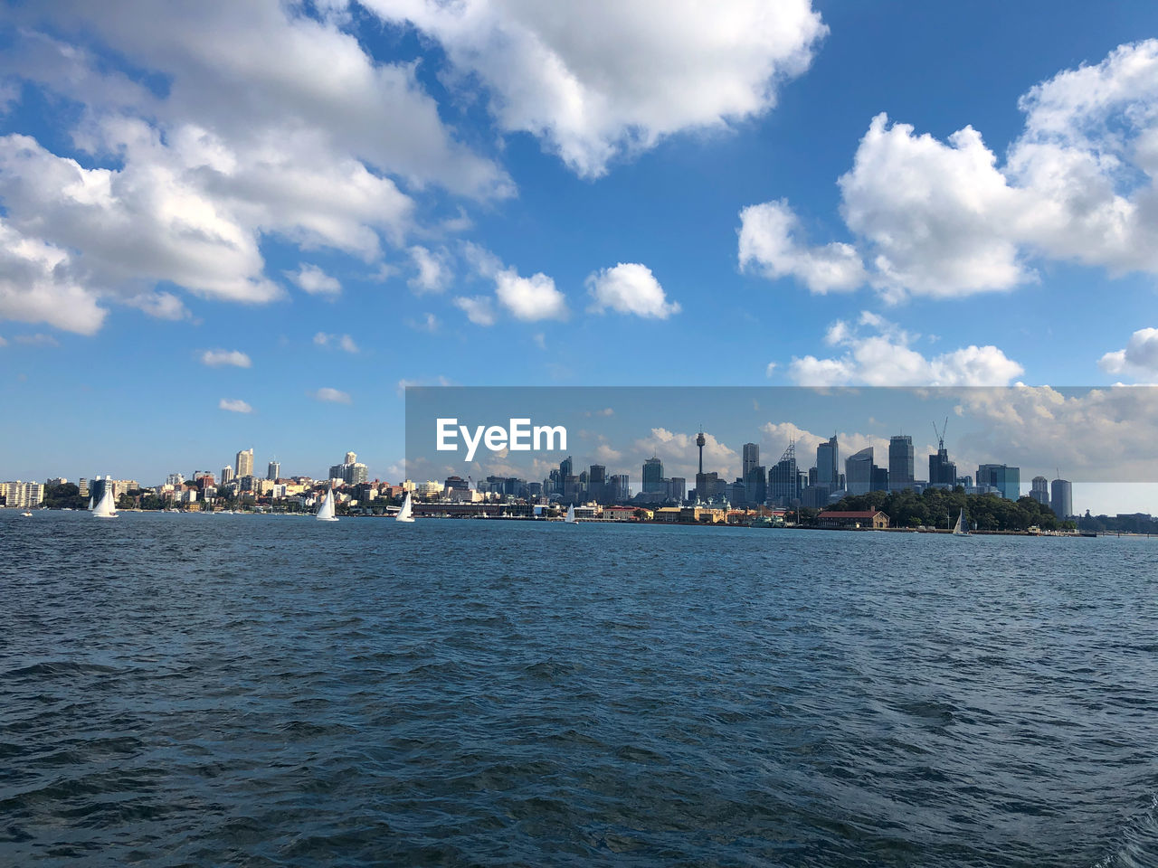 SEA AND BUILDINGS AGAINST SKY