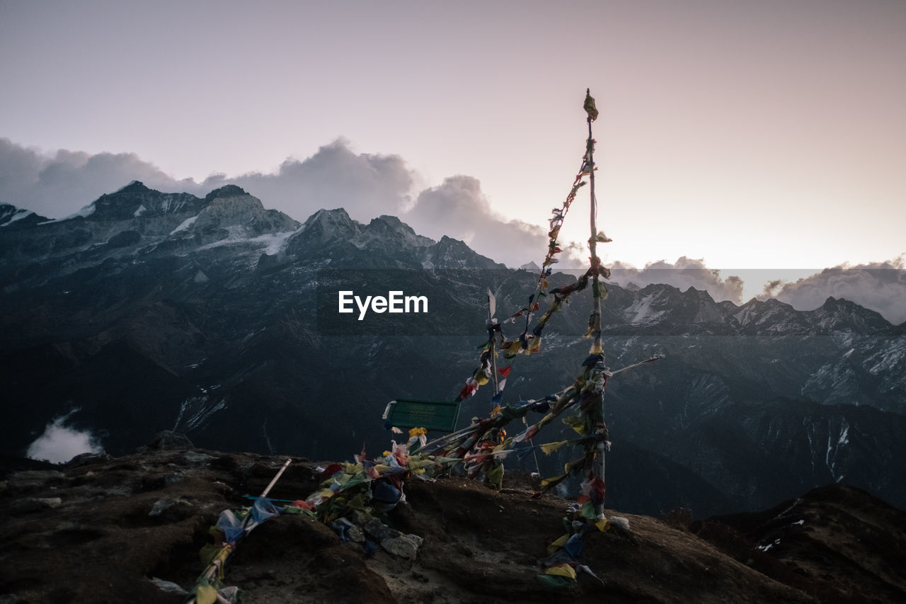 Traditional windmill on mountain against sky