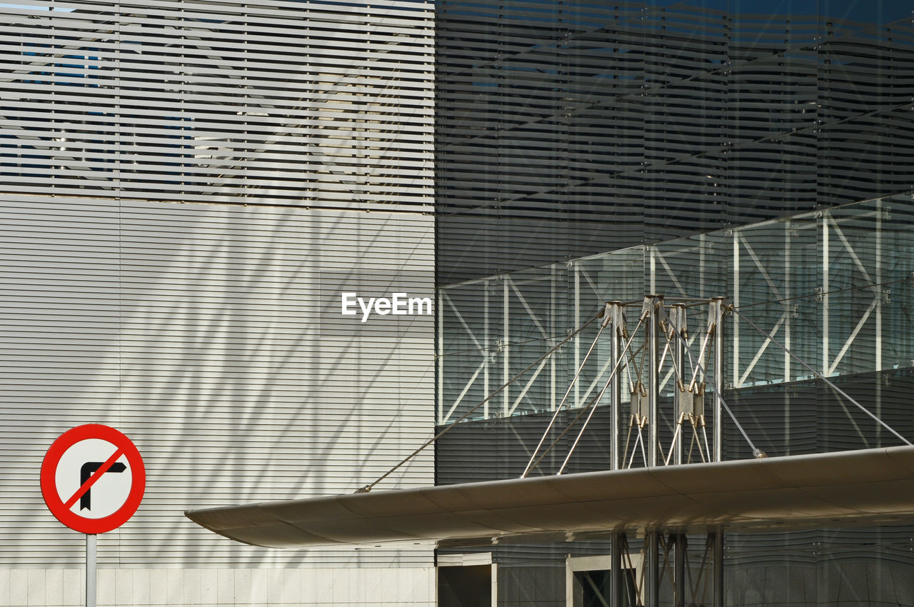 Close-up of road sign against building