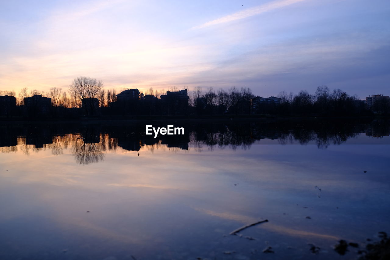 SILHOUETTE TREES BY LAKE AGAINST SKY DURING SUNSET