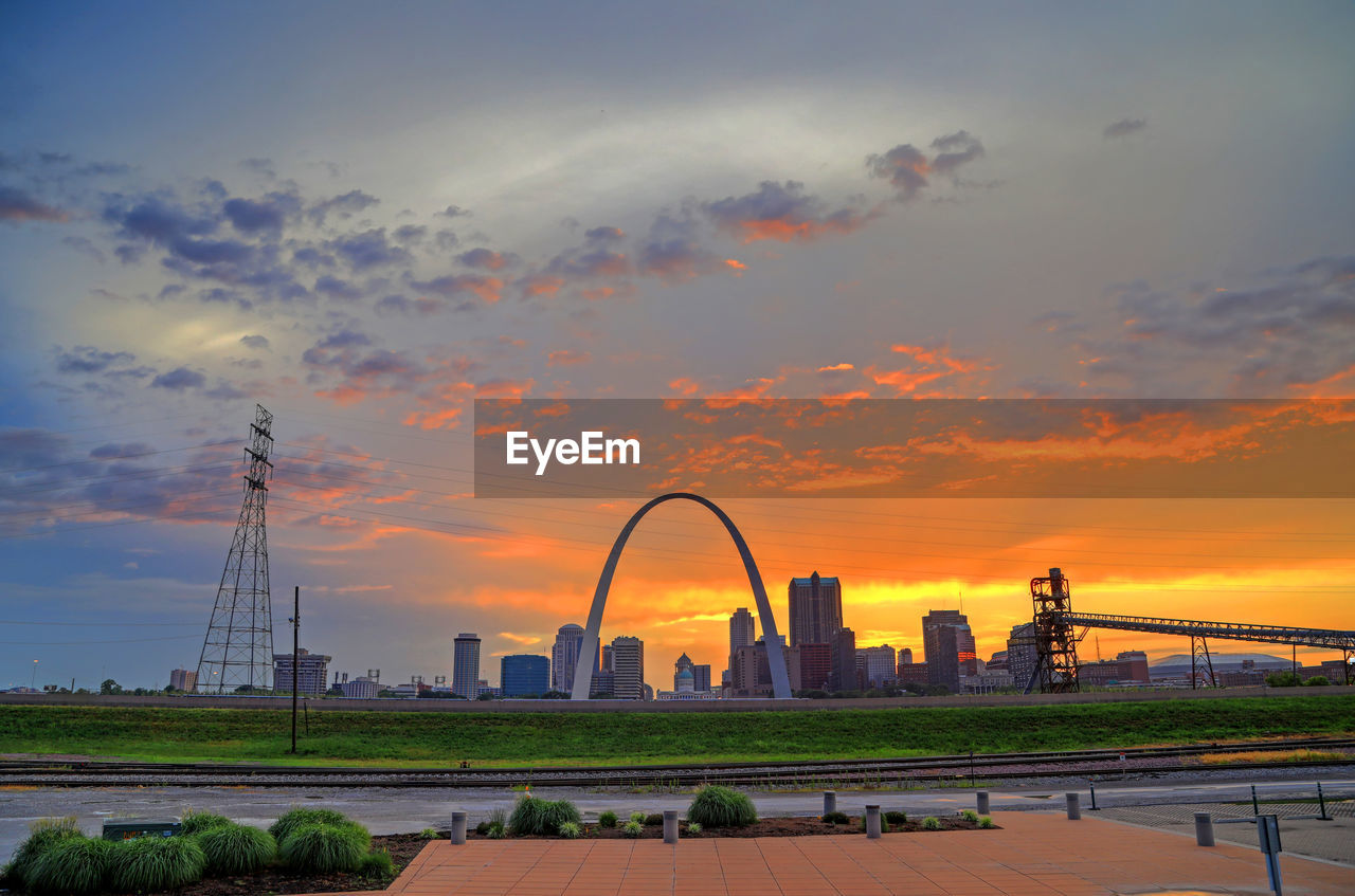 View of cityscape against cloudy sky during sunset