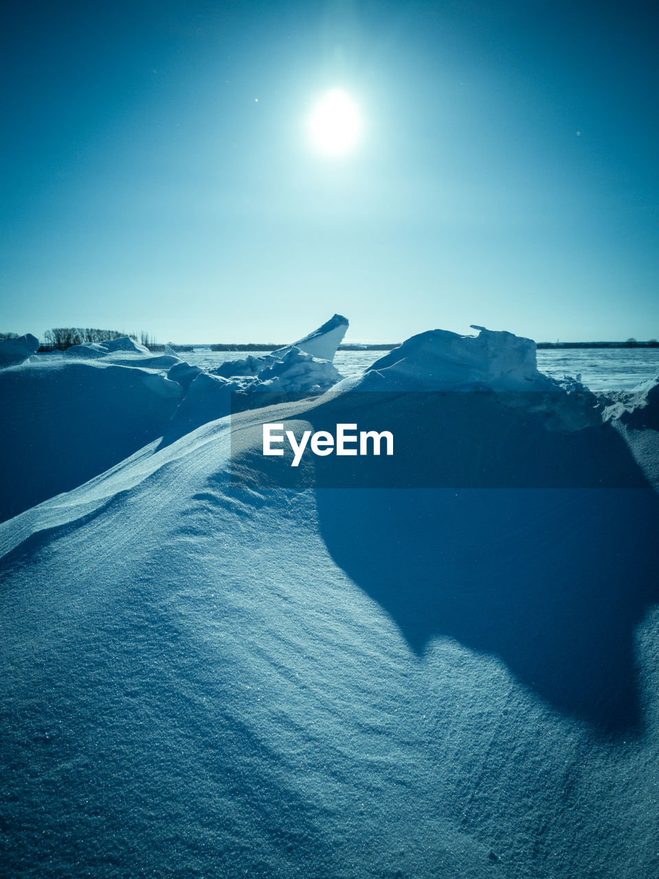 Scenic view of sea against clear sky during winter