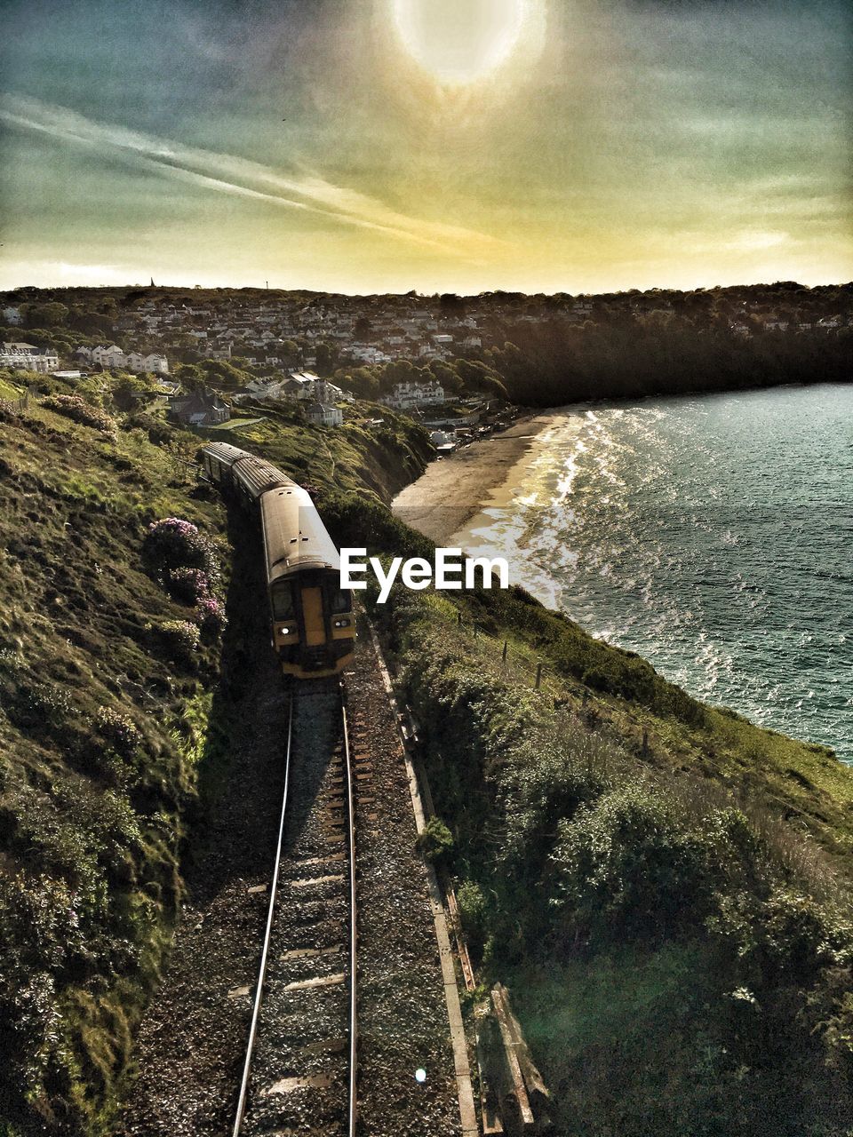 High angle view of train by sea at sunset