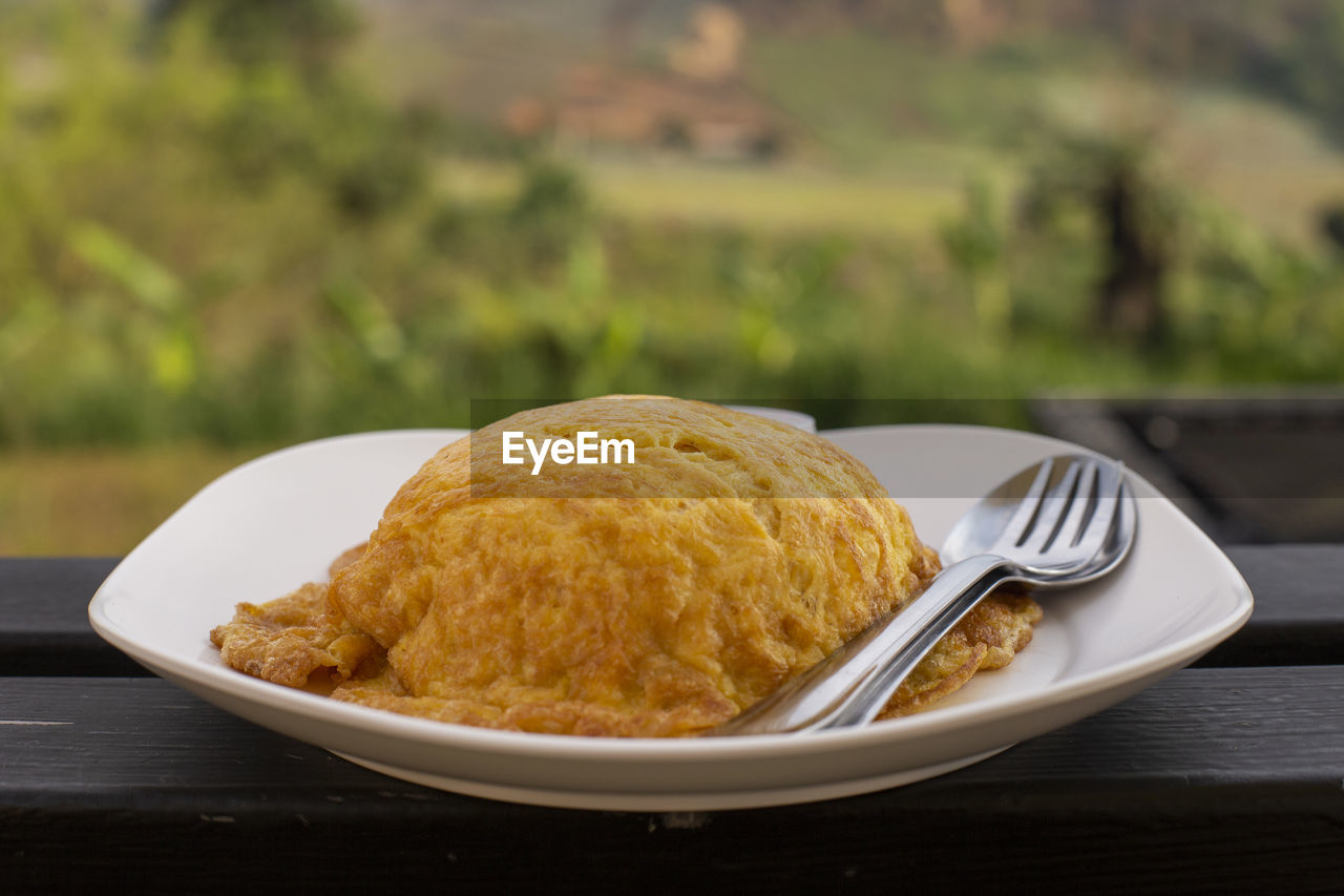 Close-up of fried egg with spoon and fork