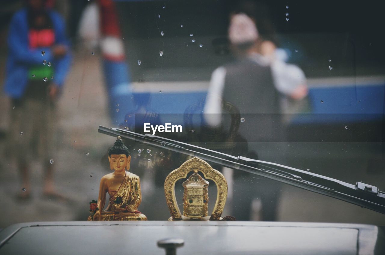 Close-up of metallic buddha in vehicle