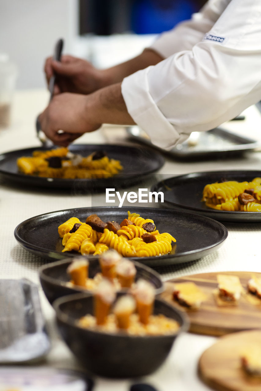 Cropped hand preparing food in kitchen