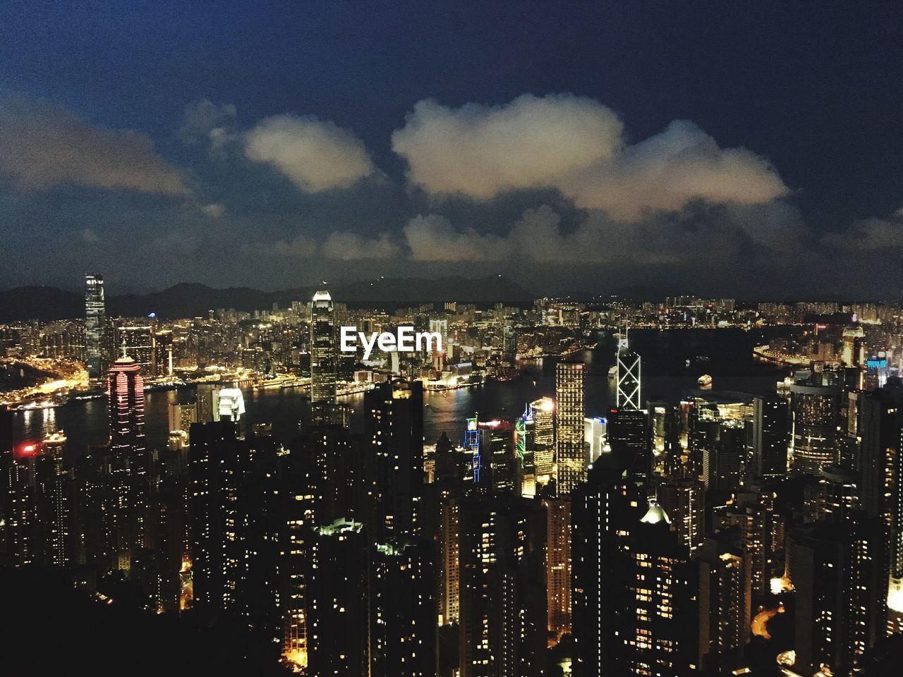 Illuminated cityscape against sky at night