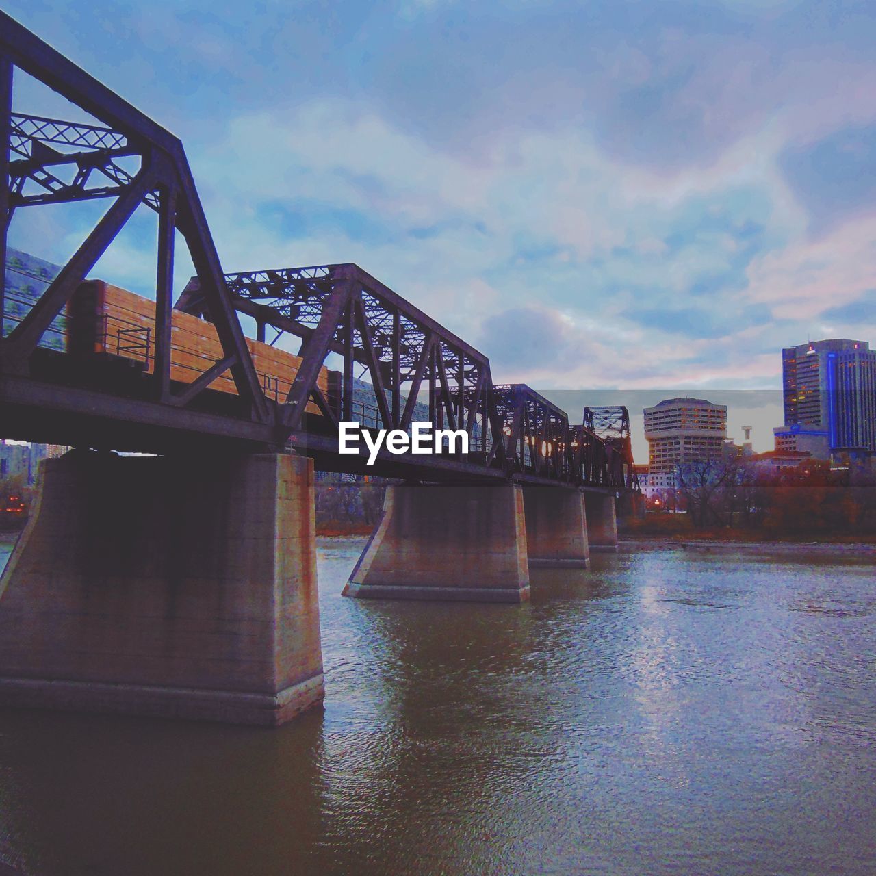 Railway bridge over river in city