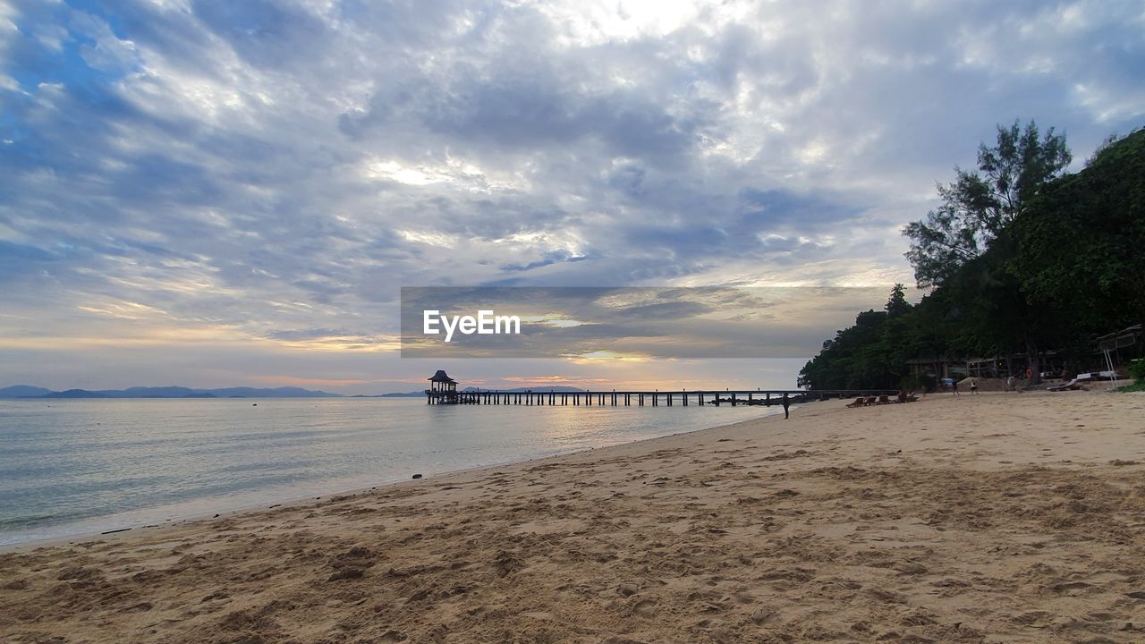 Scenic view of beach against sky during sunset