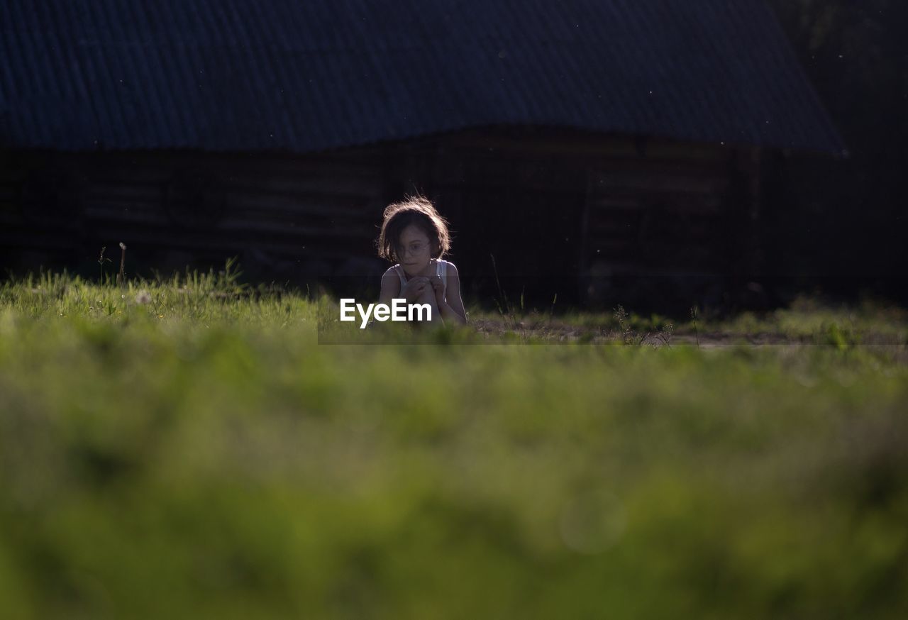 Surface level of girl sitting on land