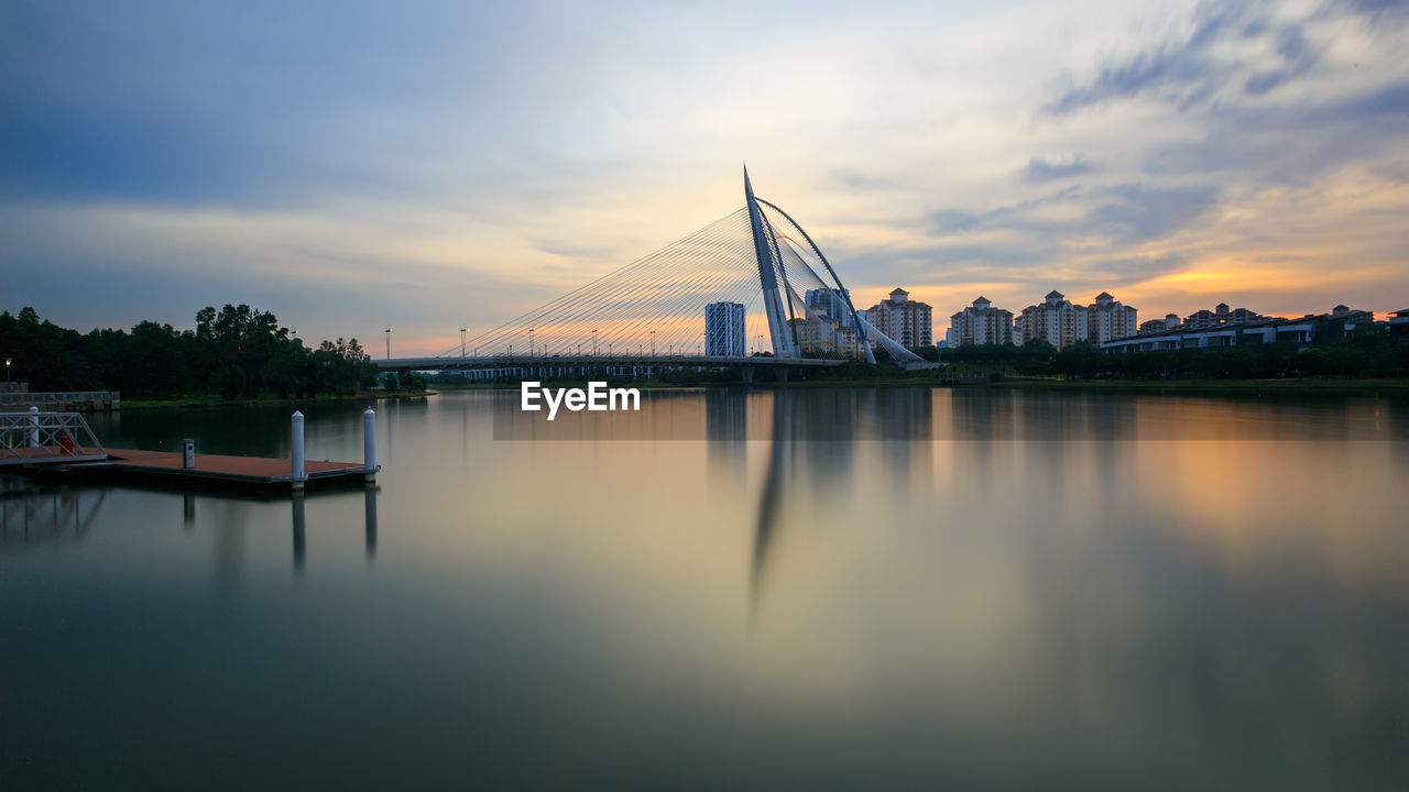 View of bridge over river at sunset