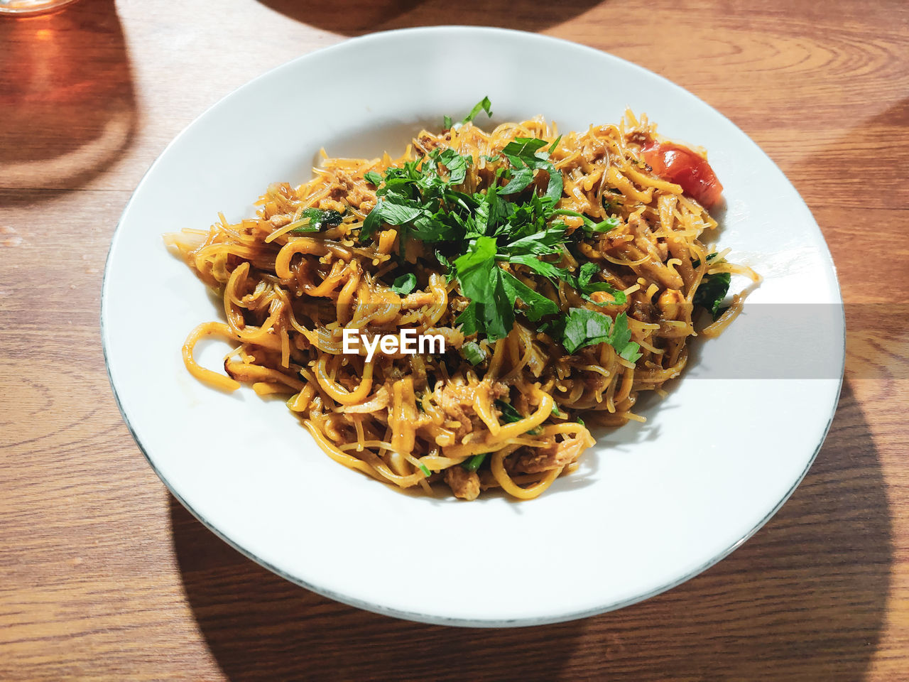 food and drink, food, pasta, italian food, table, plate, dish, healthy eating, freshness, cuisine, wellbeing, chow mein, indoors, wood, no people, meal, lo mein, fried noodles, serving size, high angle view, spaghetti, noodle, herb, still life, vegetable, produce, thai food, business, asian food, close-up, restaurant, garnish, crockery, vegetarian food, meat