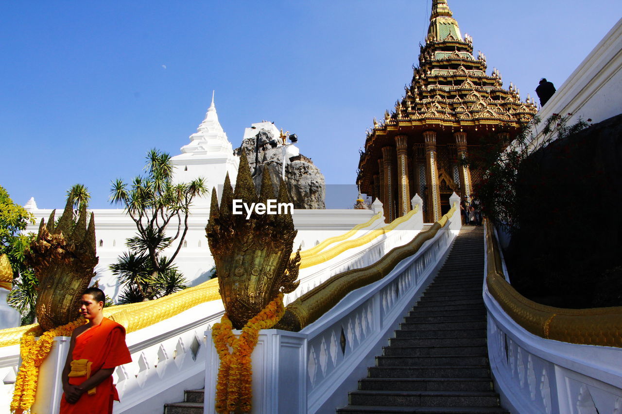 STATUE OF TEMPLE AGAINST BUILDING