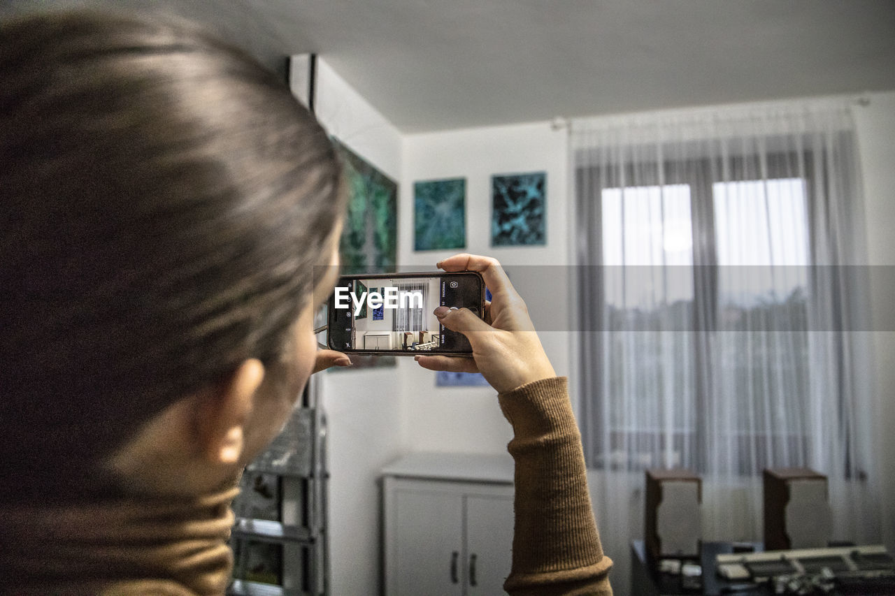 REAR VIEW OF WOMAN PHOTOGRAPHING