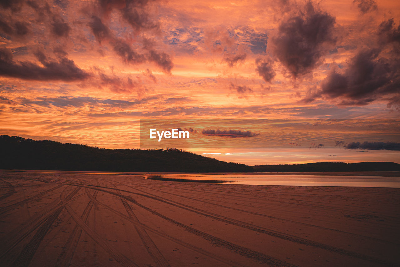 SCENIC VIEW OF LAND DURING SUNSET