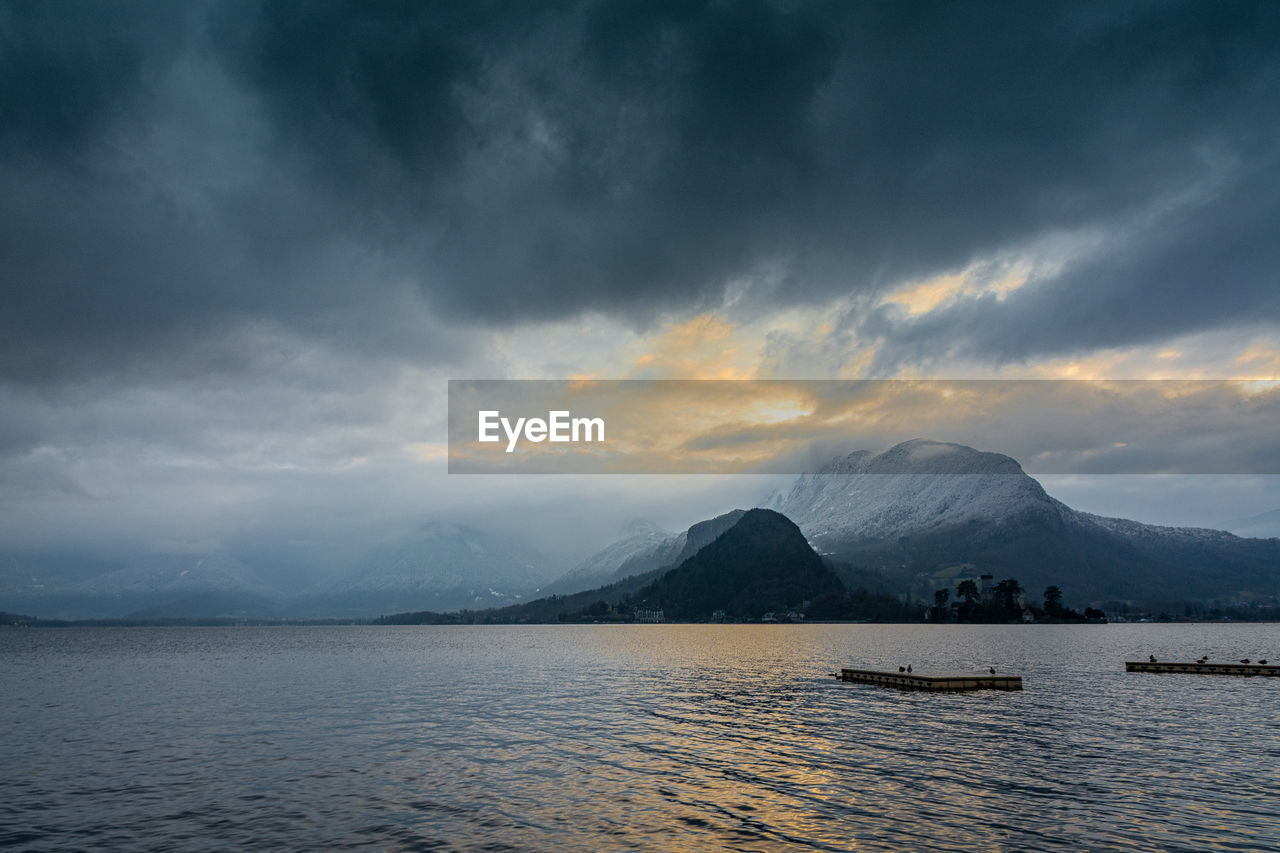 Scenic view of lake against sky during sunset