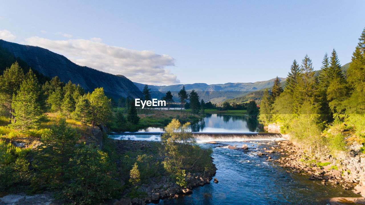 water, scenics - nature, tree, wilderness, nature, beauty in nature, body of water, mountain, plant, forest, environment, sky, river, land, landscape, autumn, reflection, pine tree, pinaceae, coniferous tree, pine woodland, tranquility, tranquil scene, no people, mountain range, travel destinations, travel, non-urban scene, valley, blue, woodland, idyllic, outdoors, cloud, day, reservoir, tourism, stream, summer, national park, vacation, sunlight
