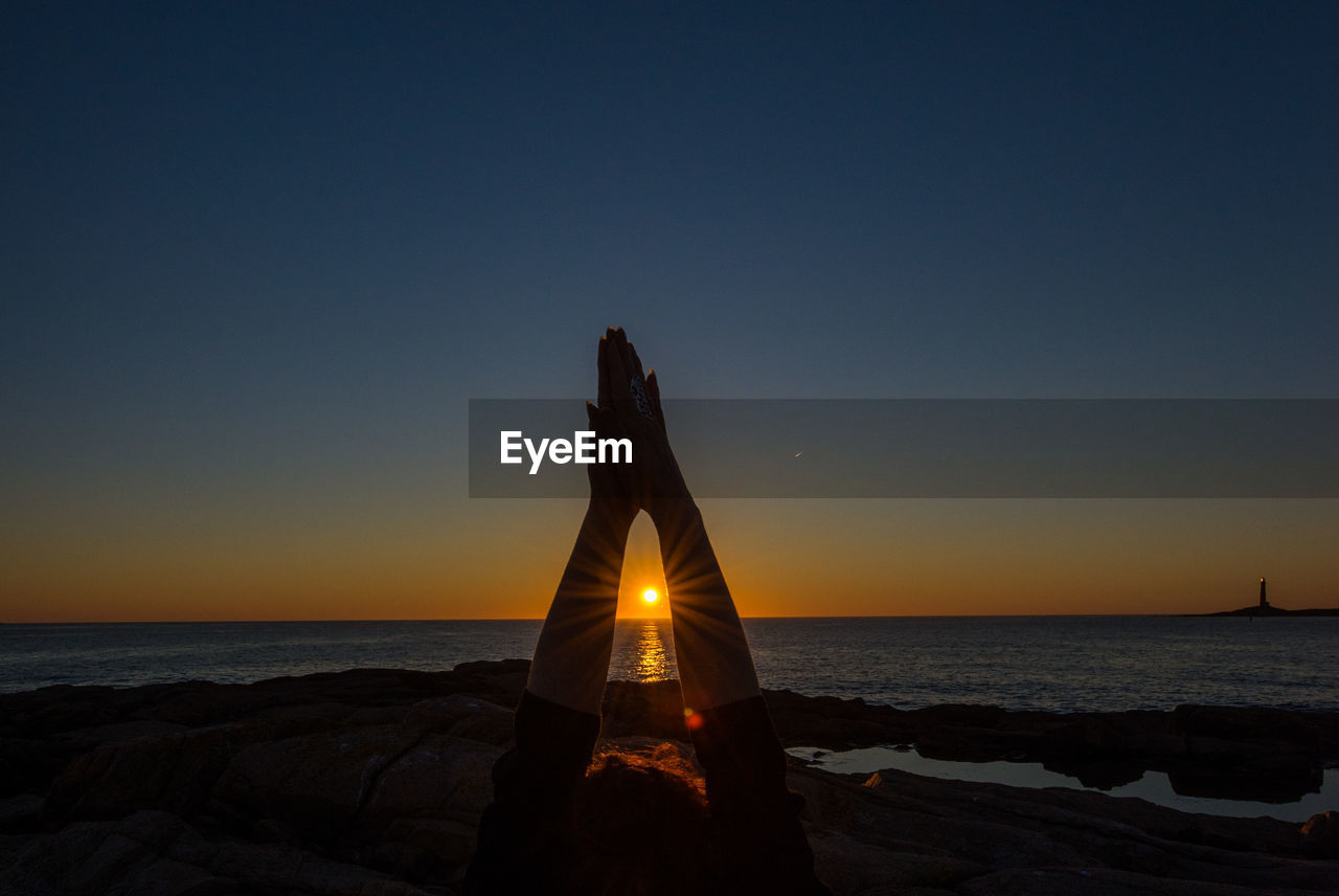 Scenic view of sea against clear sky during sunrise yoga session