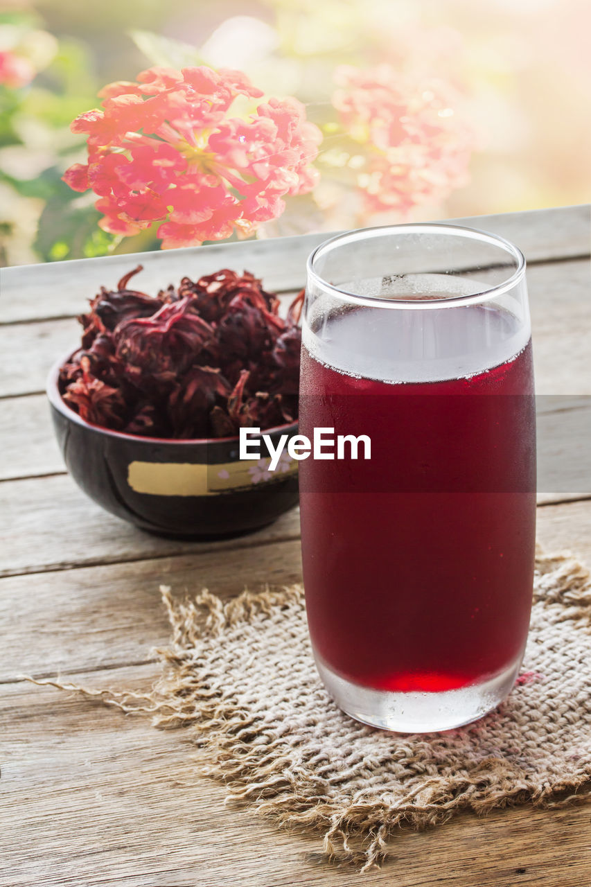 CLOSE-UP OF RED DRINK WITH GLASS OF JUICE