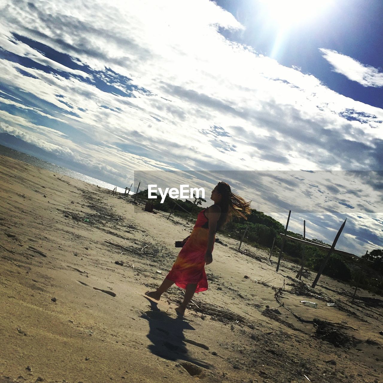 FULL LENGTH OF MAN ON BEACH AGAINST SKY