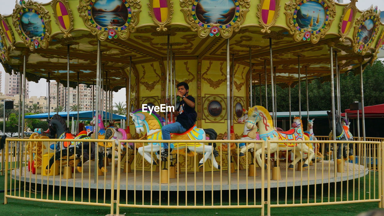 PEOPLE SITTING IN AMUSEMENT PARK