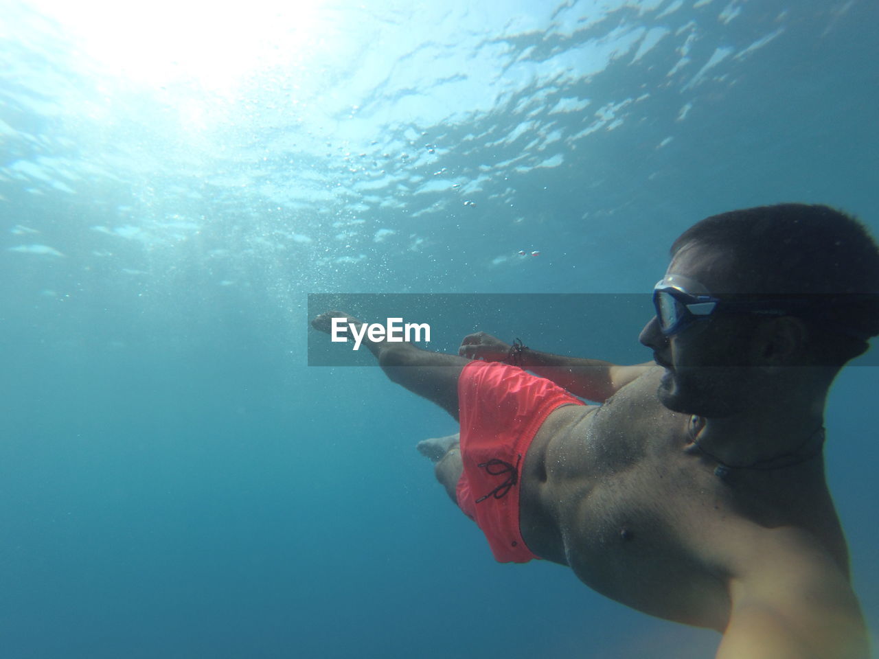 YOUNG MAN SWIMMING IN SEA