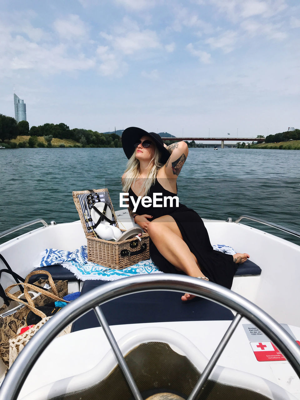 Woman sitting on boat in sea against sky