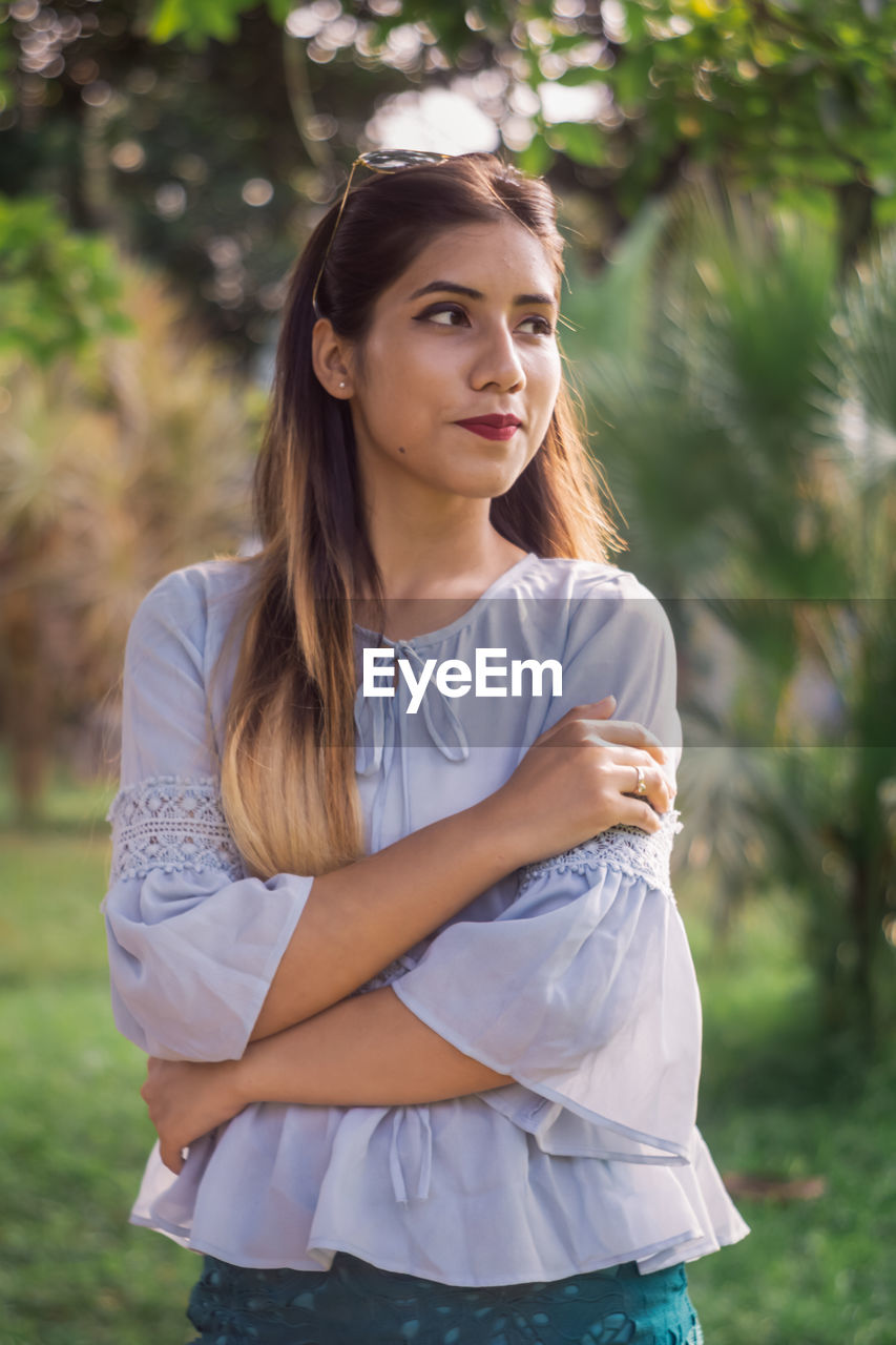 Beautiful young woman standing against outdoors