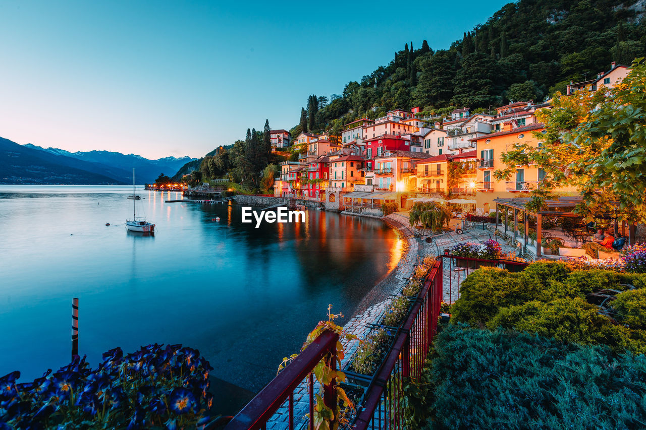 Village of varenna on lake como at sunset with illuminated houses