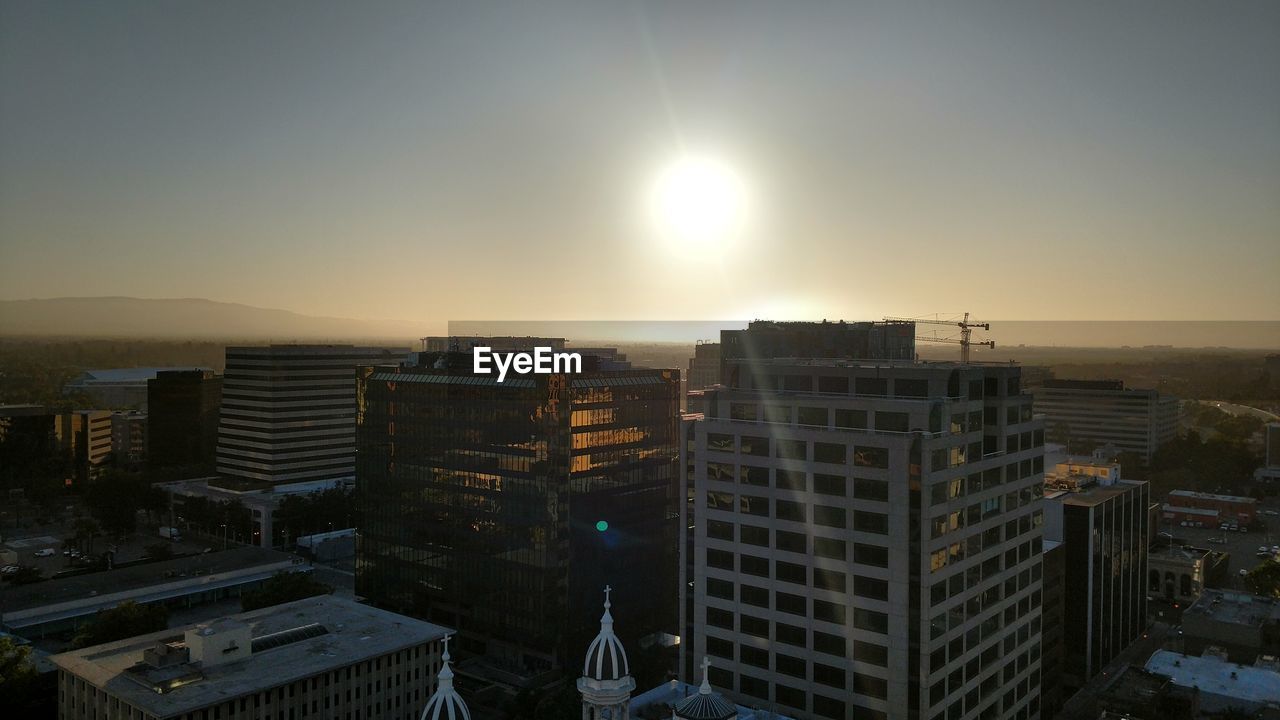 Cityscape against clear sky during sunset