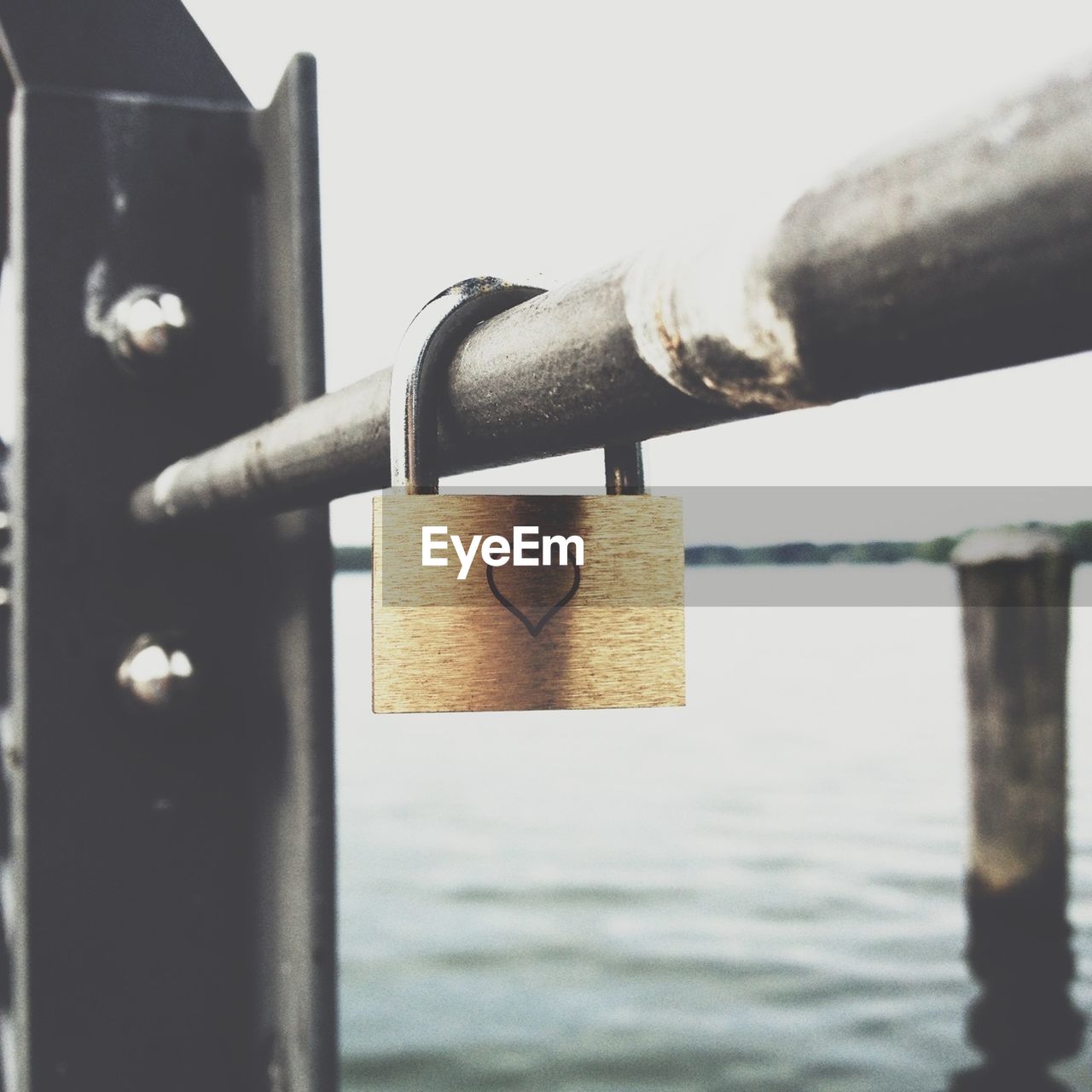 Close-up of a love padlock hanging on railing