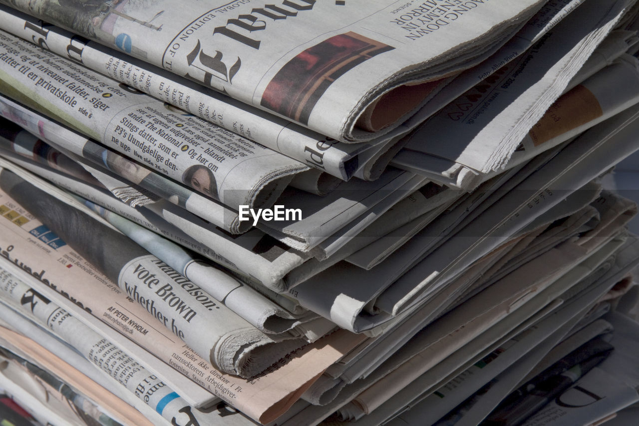 Close-up of stacked newspapers