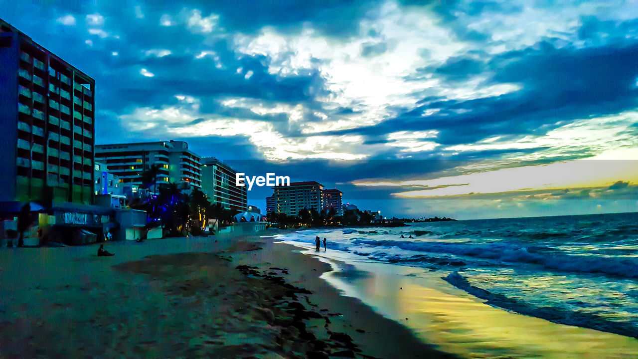 View of beach against cloudy sky