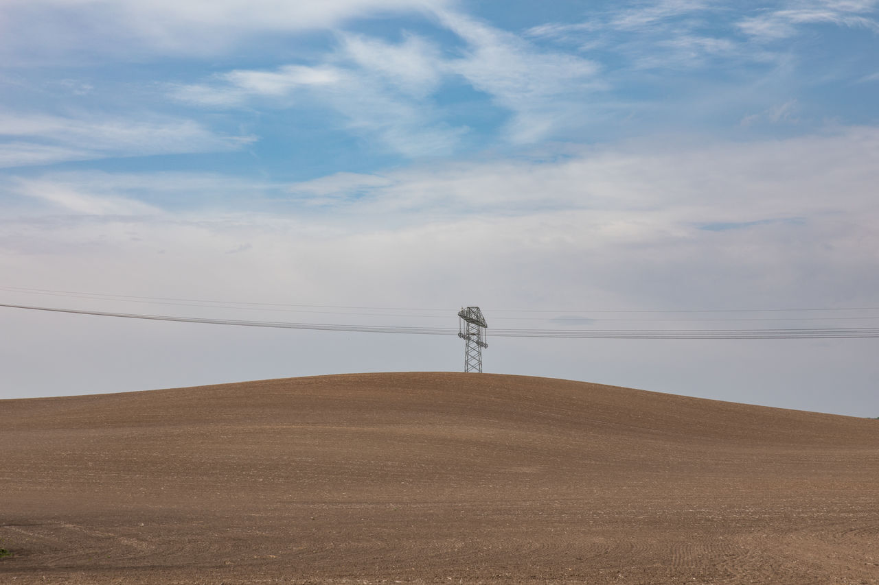 sky, natural environment, cloud, land, environment, horizon, landscape, plain, sand, scenics - nature, nature, prairie, grassland, beauty in nature, field, steppe, tranquility, tranquil scene, day, non-urban scene, remote, desert, wind, solitude, outdoors, sea, hill, sand dune, no people, horizon over land, plateau, power generation