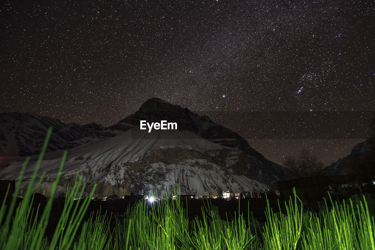 Scenic view of mountains against sky at night